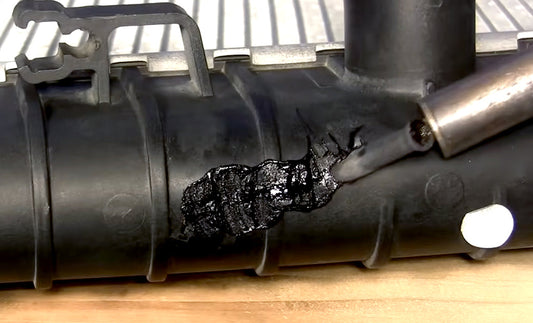 An airless plastic welder smoothing a weld on a radiator