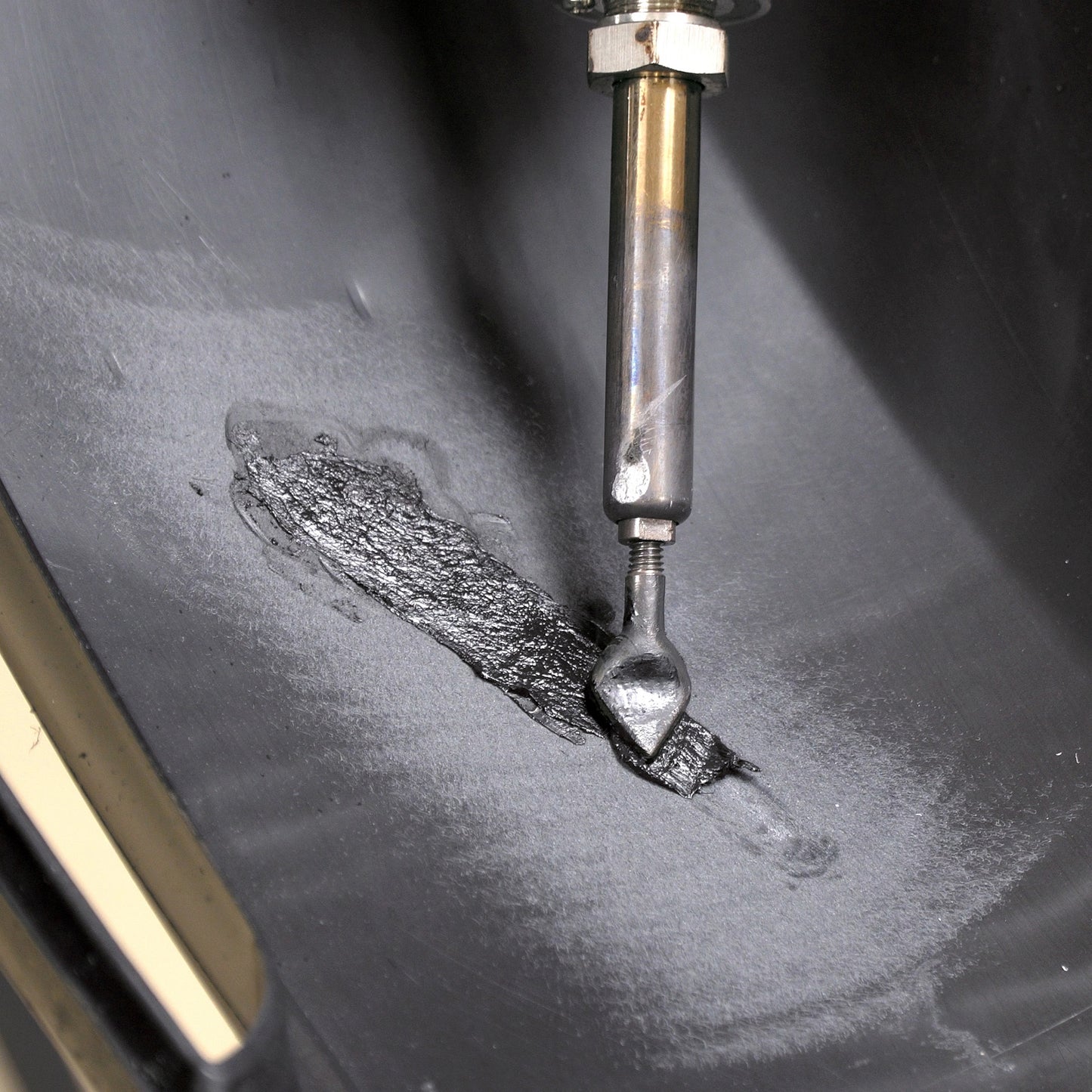 A bumper cover is being repaired with the airless plastic welder and FiberFlex repair rod