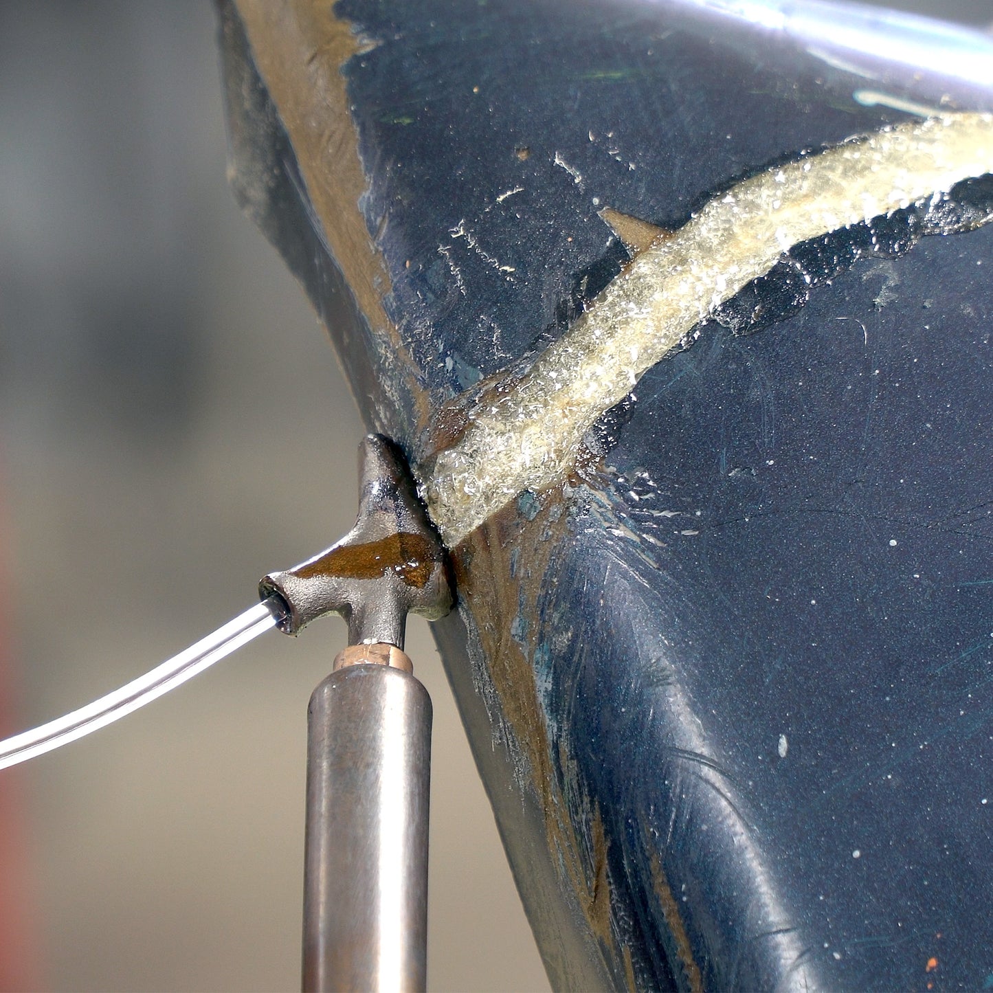 A polyurethane bumper cover is being repaired with the airless plastic welder and polyurethane welding rod