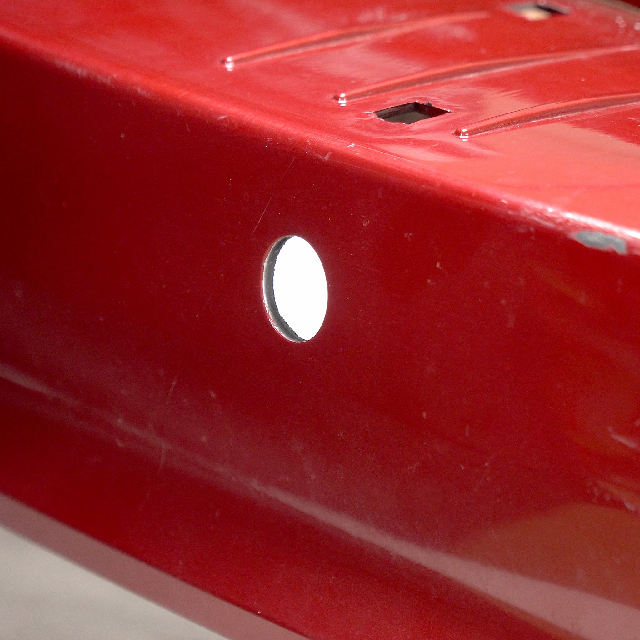 A new hole cut into a bumper cover