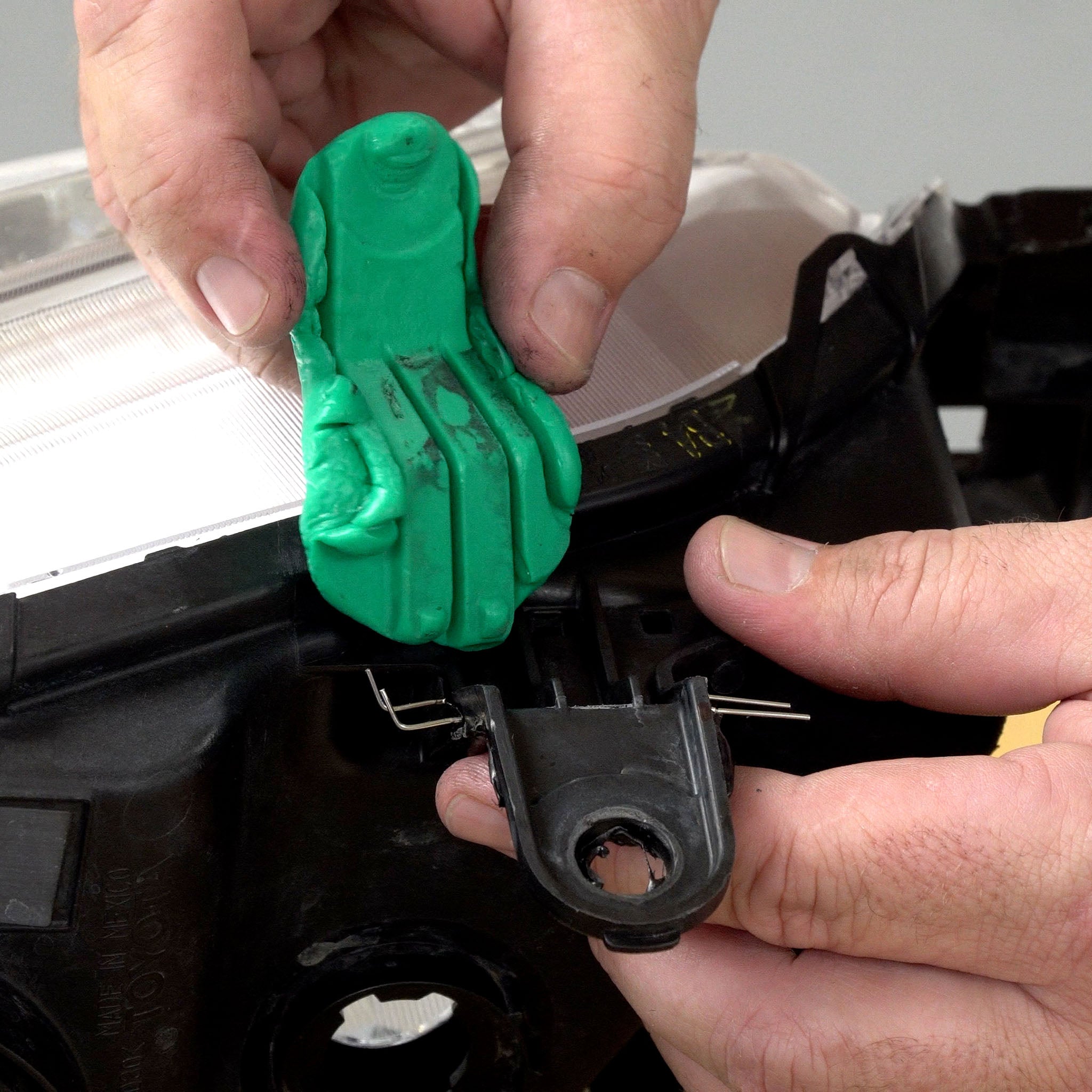 An impression of a headlight tab formed into the putty