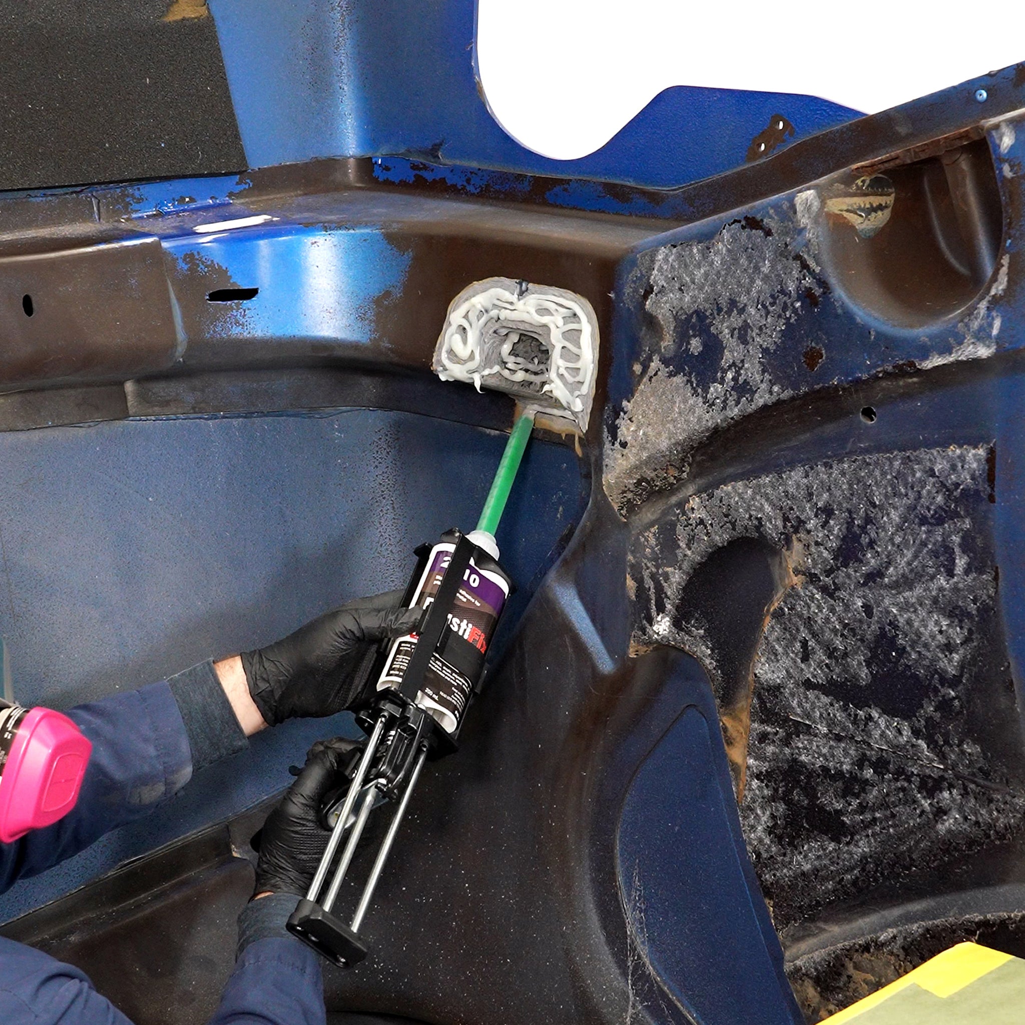 Applying PlastiFix to the sanded area of the hood