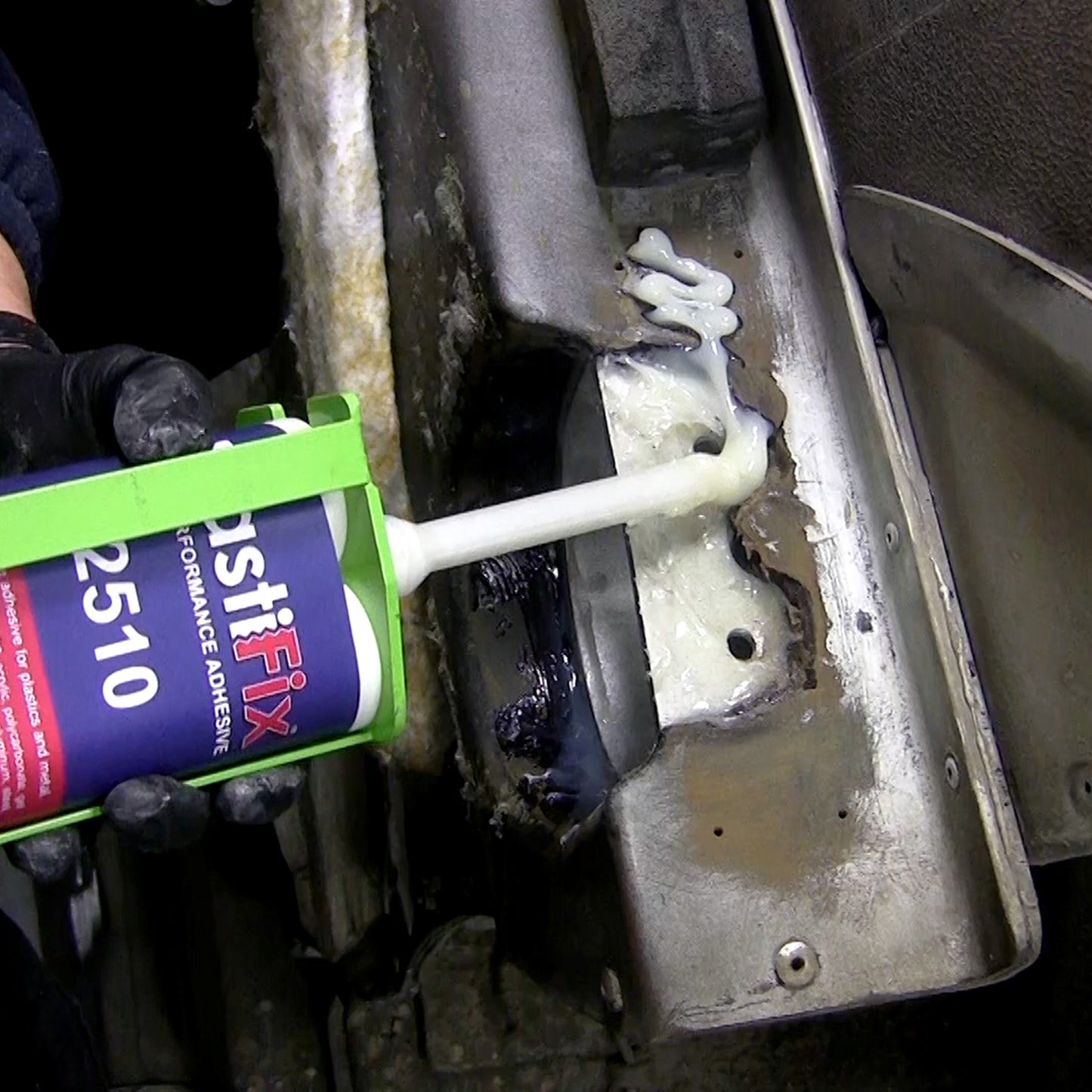 Applying PlastiFix over the plug and sanded area of the hood