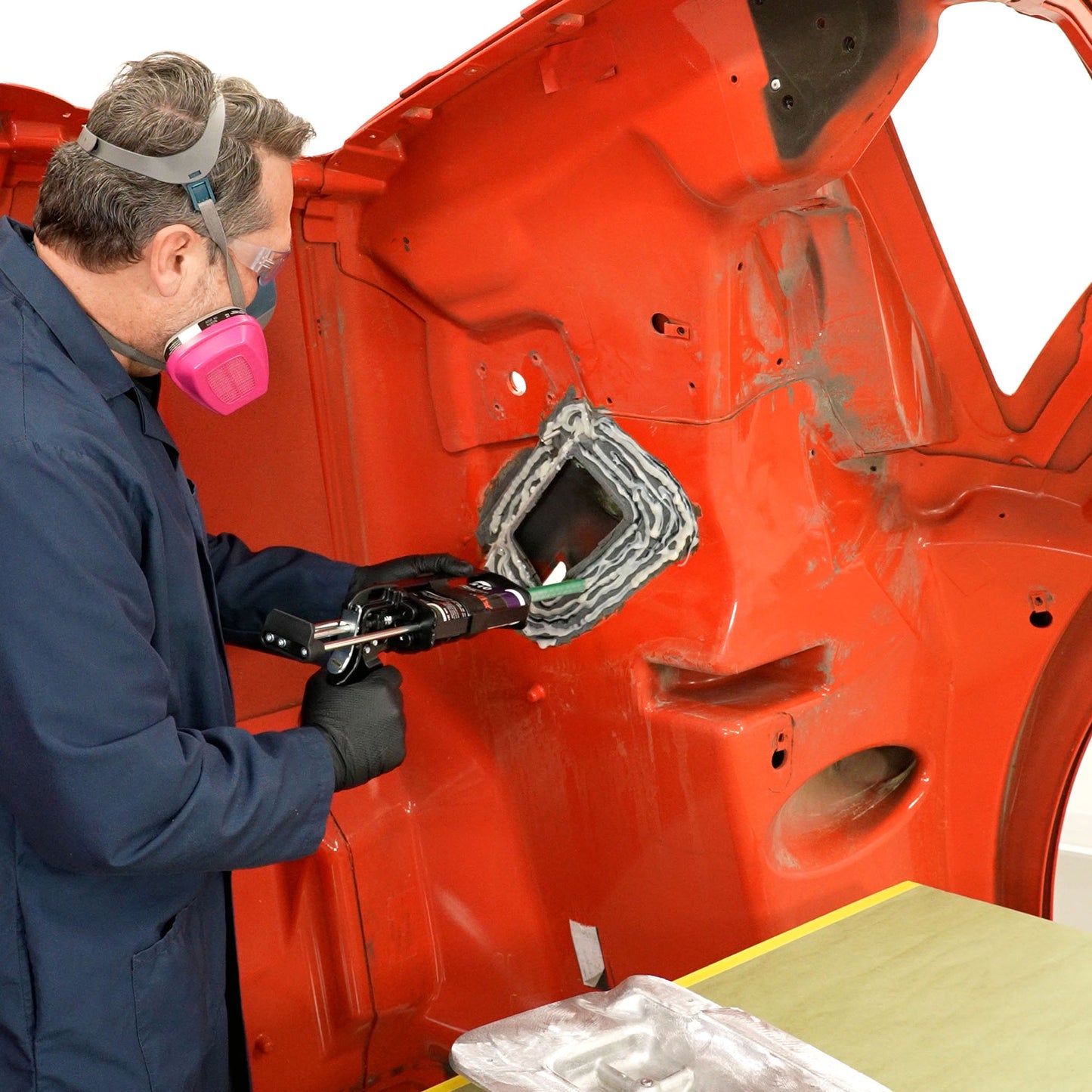 Applying PlastiFix adhesive to the hood