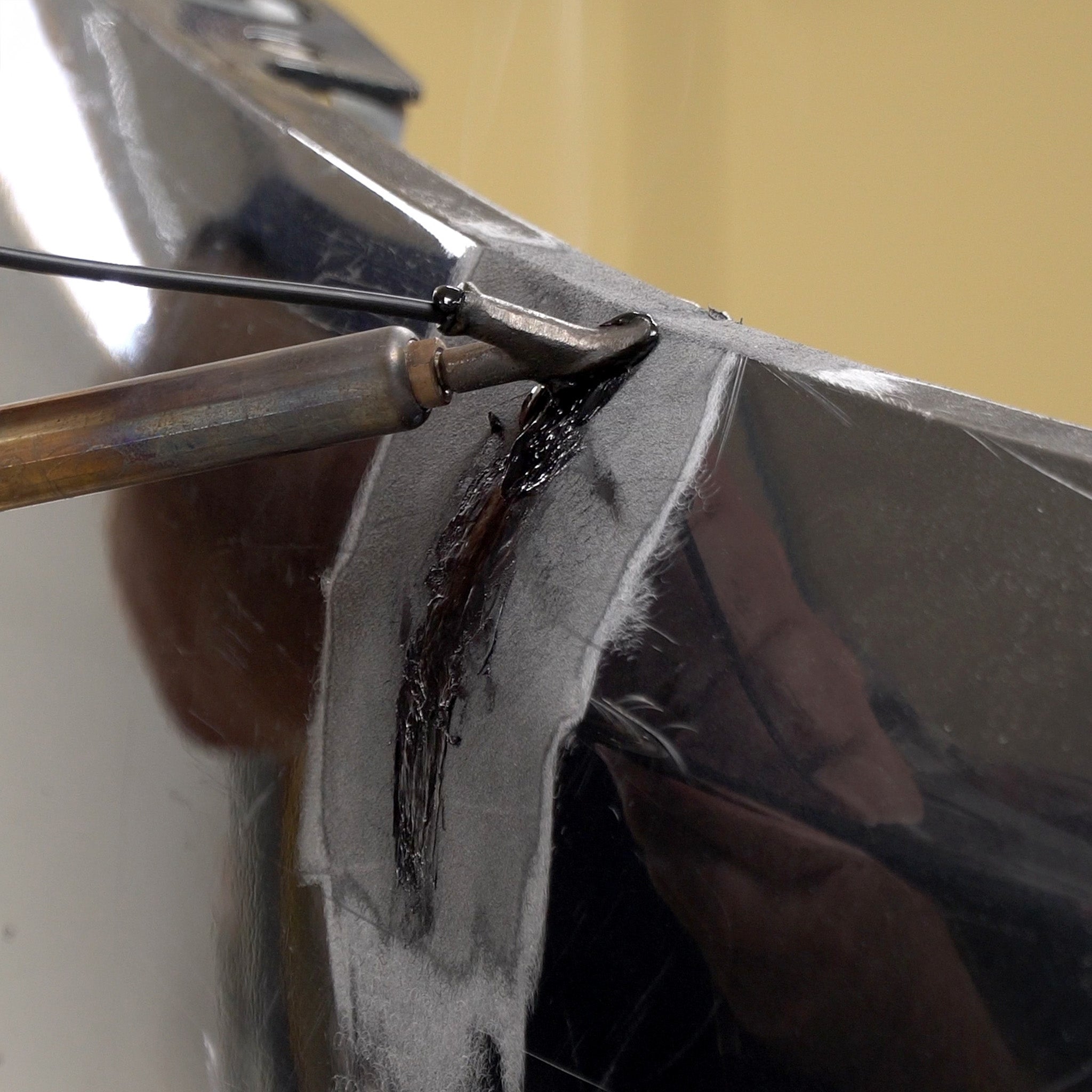A bumper cover is being welded with the airless plastic welder and polypropylene welding rod