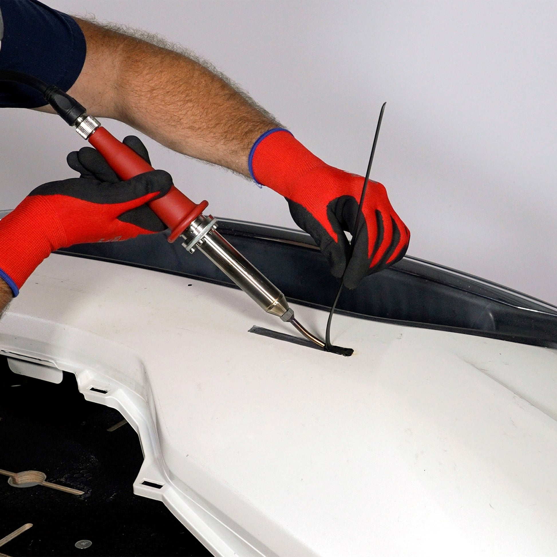 A bumper cover is being welded with the nitrogen plastic welder and polypropylene welding rod