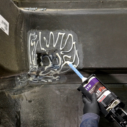 Applying the PlastiFix adhesive to the sanded area of the hood