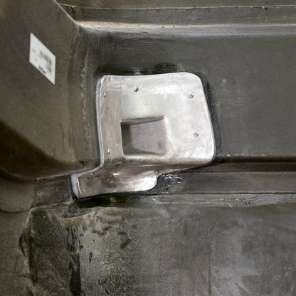The aluminum casting secured to the hood