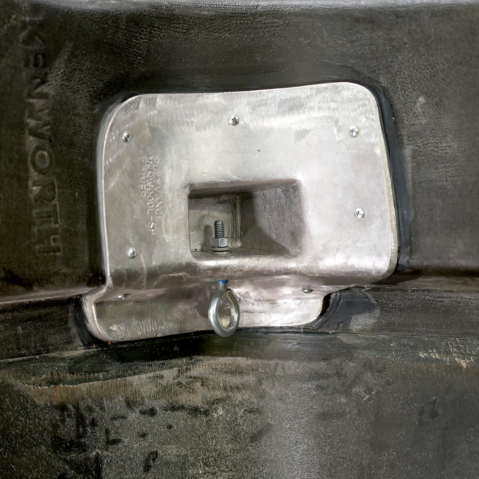 The aluminum casting in the hood with the eyebolt inserted