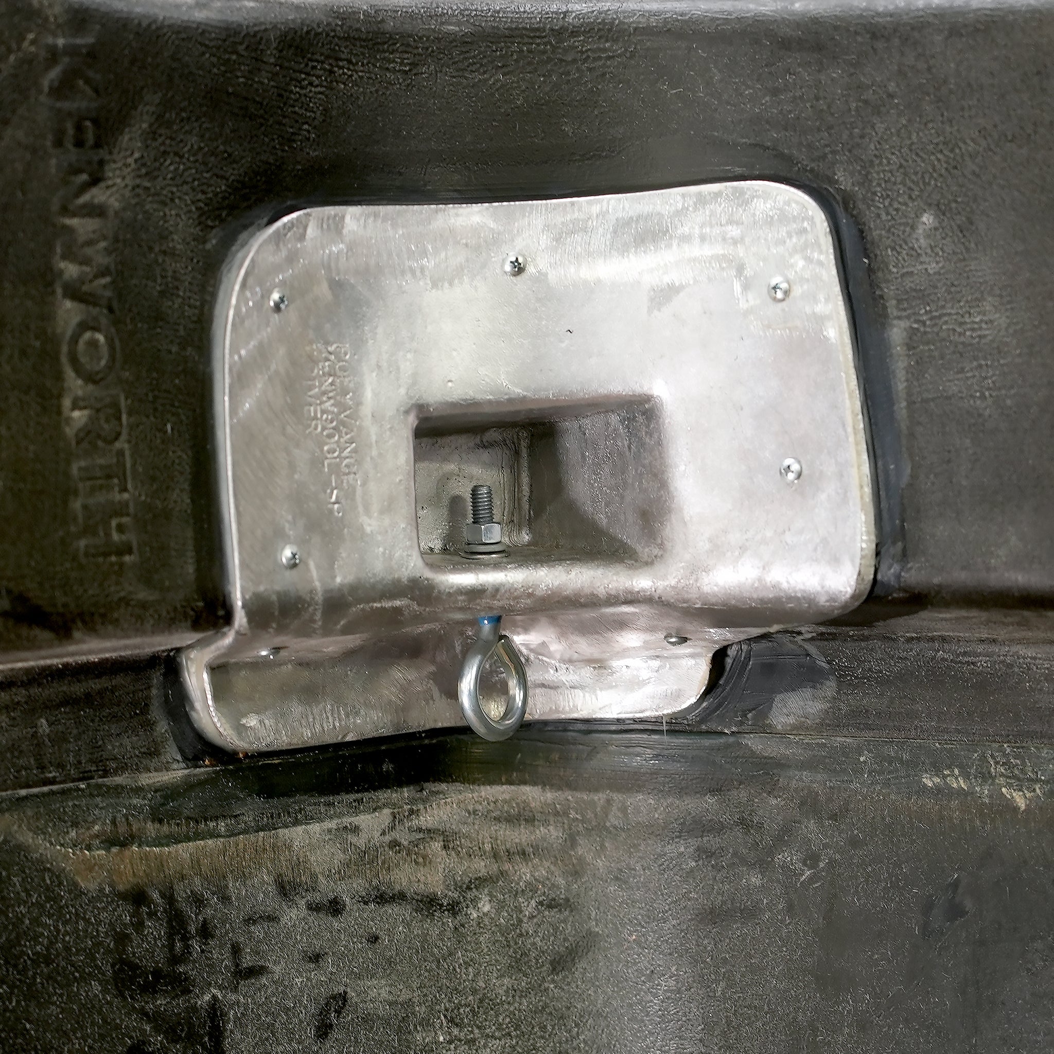 The aluminum casting in the hood with the eyebolt inserted