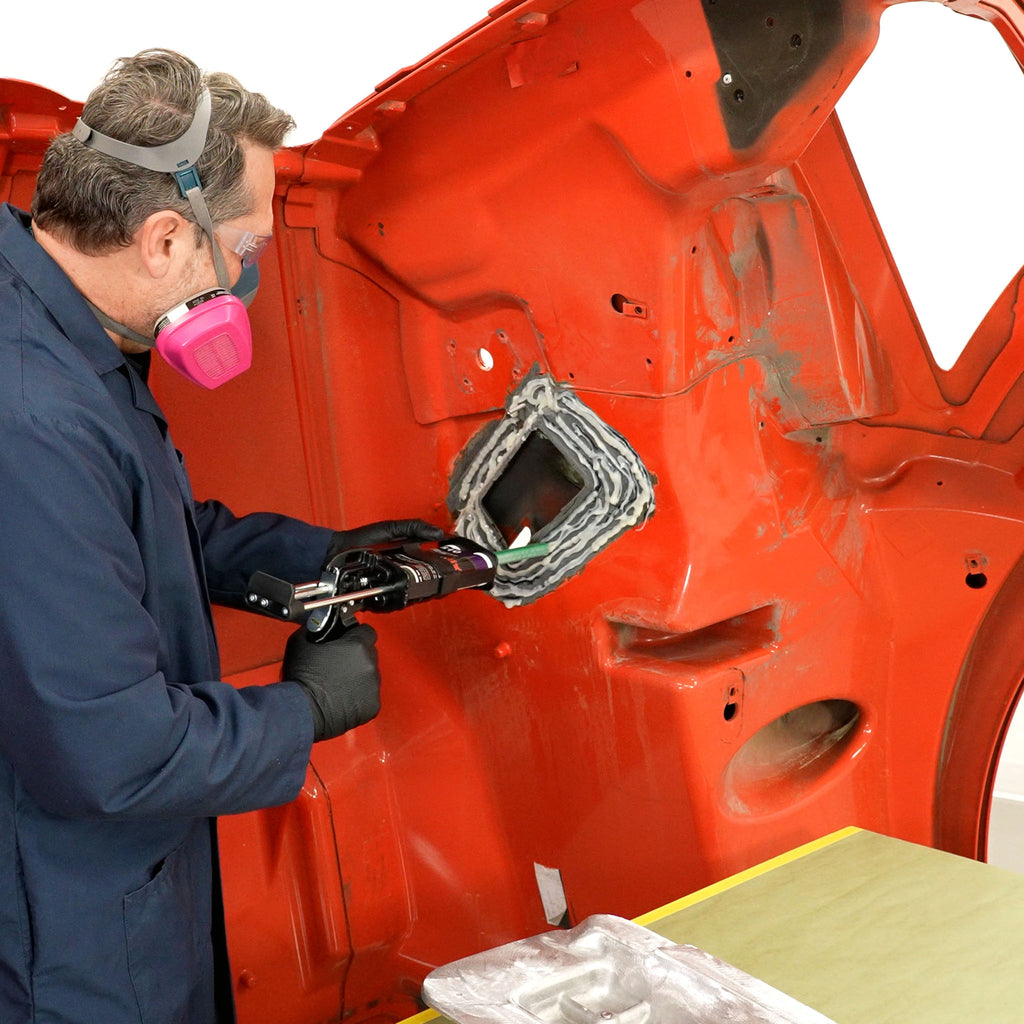 Applying PlastiFix adhesive to the hood