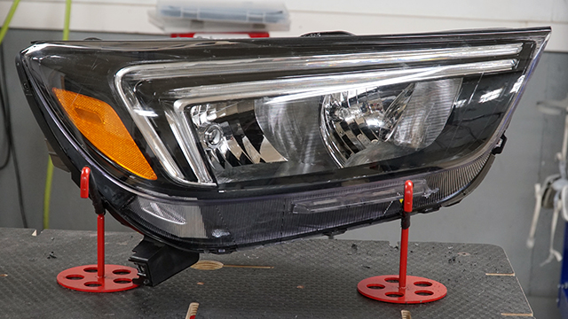 The headlight is viewed from the front. The repaired areas are not visible.