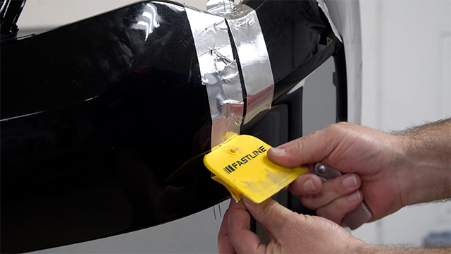 Applying aluminum tape over staples 