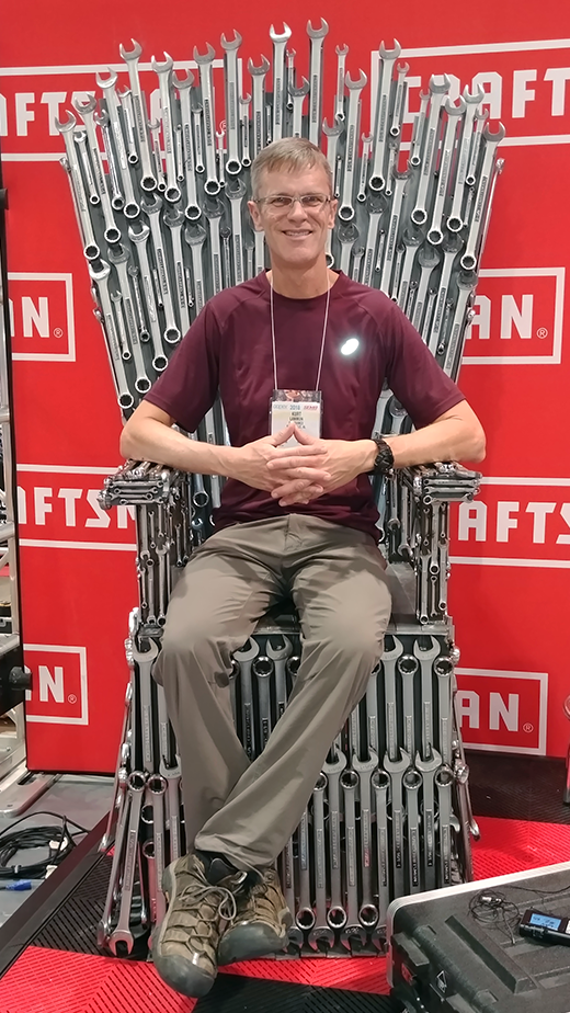 Kurt sitting on a throne made of wrenches