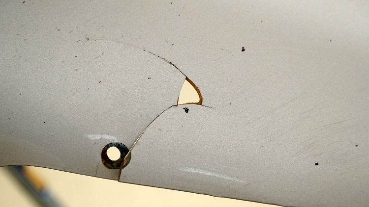 Hole in the bedside panel before repairing.