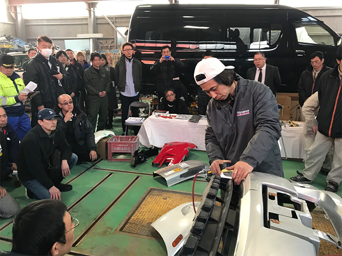 Ikuo Tanaka performing a welding demonstration for a crowd.