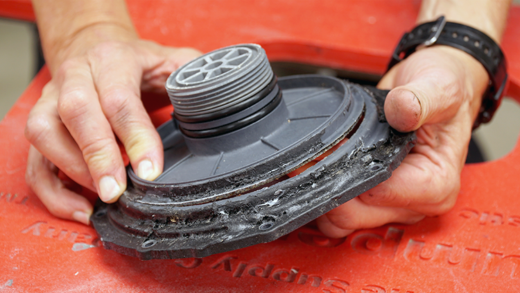 A pool pump housing with Flex Seal covering it. It has a large crack in it.