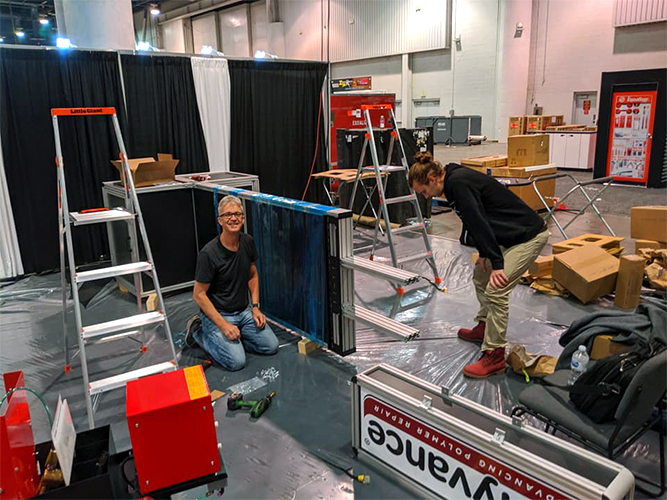 Keith and his son work on the booth.