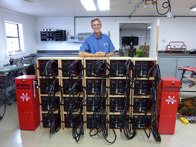 Kurt in front of a stack of 6085 Nitro Fuzer nitrogen plastic welders.