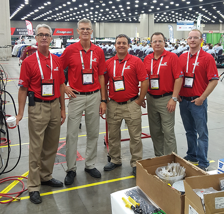 Five men in red shirts.