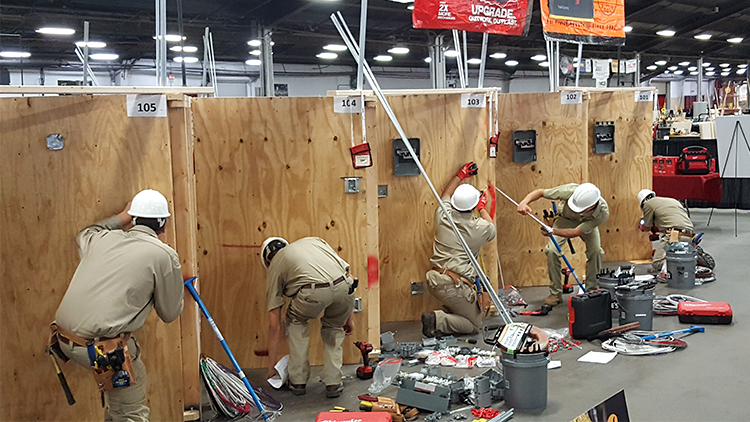 Competitors doing electrical work.