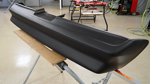 The 1978 Trans Am rear bumper after it has been repaired and primed.