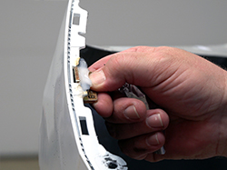 Removing the aluminum tape and number 6 die from the newly formed tab.