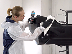 A man cleaning a bumper with Polyvance's Super Prep Plastic Cleaner